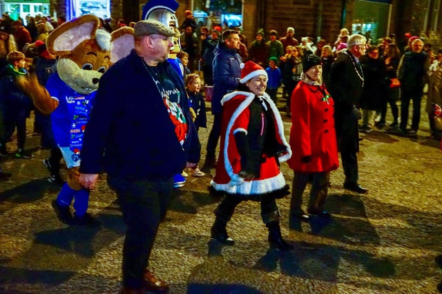 Mayor Steve Flitter, right, helped lead the parade, a lost tradition revived for this year.