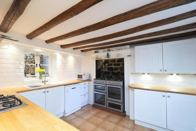 The kitchen at the Riddings cottage is very distinguished, particularly with its feature range cooker. Note also its inset gas hob and extractor hood over, dishwasher, tiled flooring and spotlights.