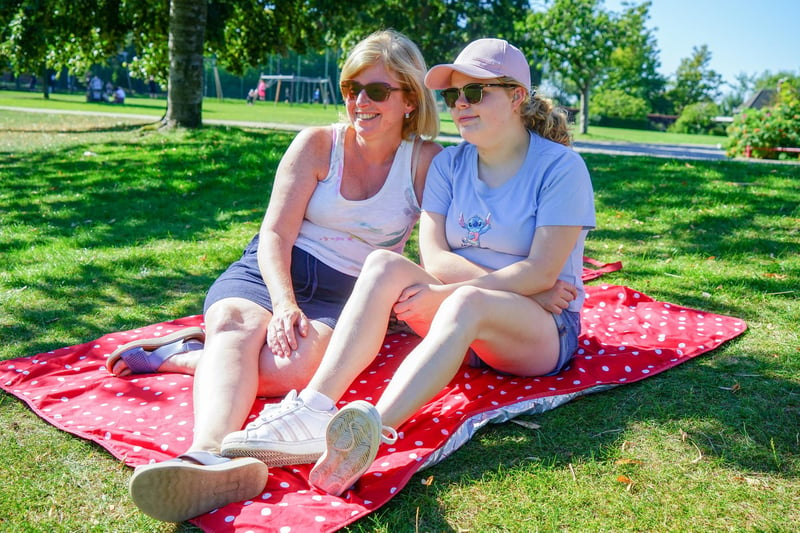 Mum and daughter relaxing in the sunshine in Queen's Park, Chesterfield.