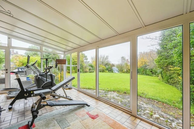 The garden room features double-glazed windows from floor to ceiling and sliding patio doors which open to the garden. It is currently used as a gym.