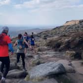 Members of Peak Running explore the Peak District National Park landscape.
