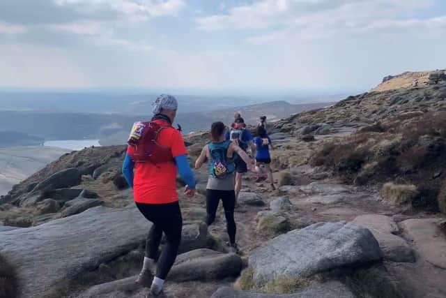 Members of Peak Running explore the Peak District National Park landscape.