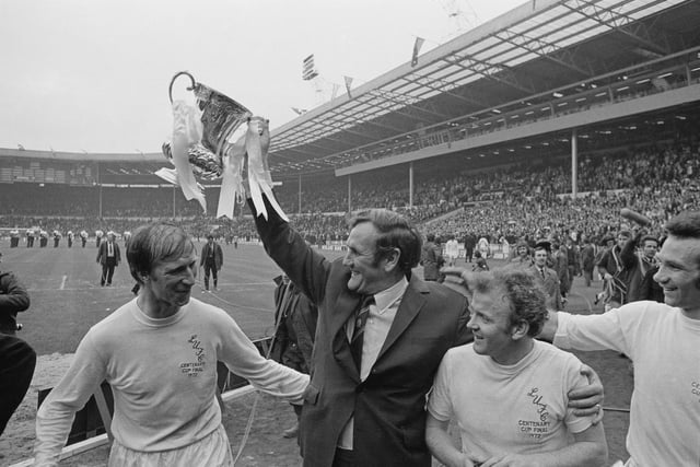 Don Revie lifts FA Cup after his players defeated Arsenal to win the final at Wembley Stadium. Also shown are Jack Charlton, Billy Bremner and Paul Reaney.
