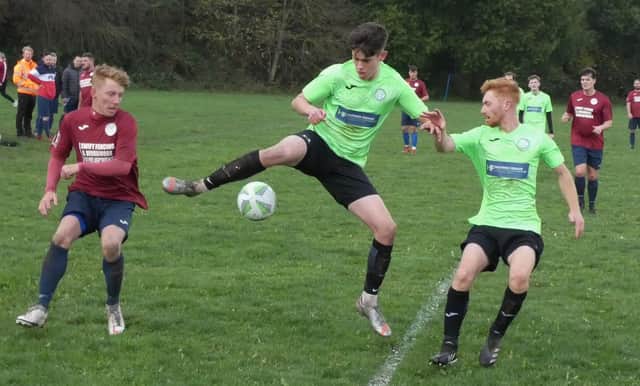 Action from the Division Four game between Clay Cross Utd (maroon) and Royal Oak Whitwell. Photo by Martin Roberts.