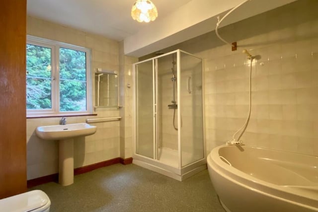 This spacious bathroom contains a large shower cubicle, a bath, hand basin and wc.