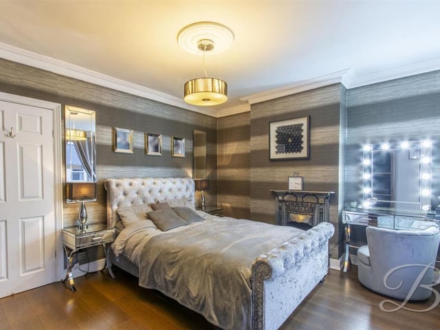 With feature fireplace, laminate flooring and two windows to the front elevation.