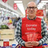A Tesco volunteer holding a shopping list guide for donations last year. Photo by Pete Maclaine/ParsonsMedia.net.