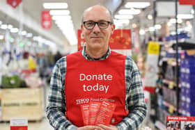 A Tesco volunteer holding a shopping list guide for donations last year. Photo by Pete Maclaine/ParsonsMedia.net.