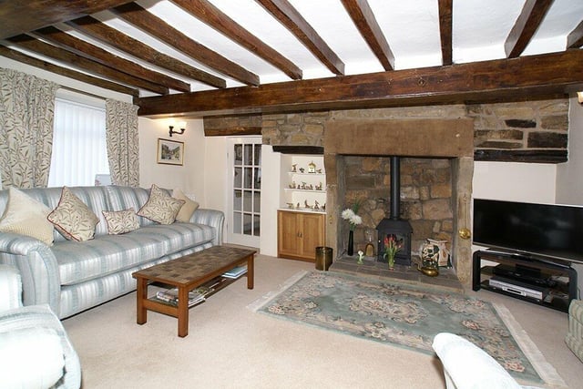 The fireplace in the lounge has a dressed stone surround and corbelled lintel and houses a living flame gas stove. There are original ceiling beams and a window seat.