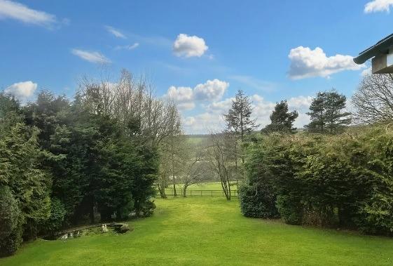 Fabulous view of the countryside beyond the rear garden which contains a pond.