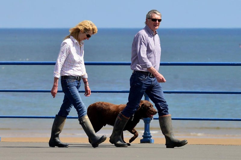 Dog walkers stepping our as they make their way along the promenade at Seaton Carew.