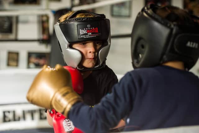 Boxer Caden James, 5, spars with Danson Healey, 6. (Photo: SWNS).