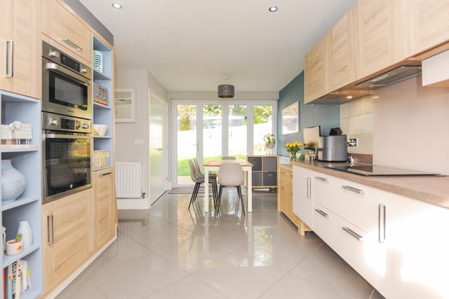 The open-plan fitted kitchen/diner with integrated appliances has bi-fold doors leading to the garden.