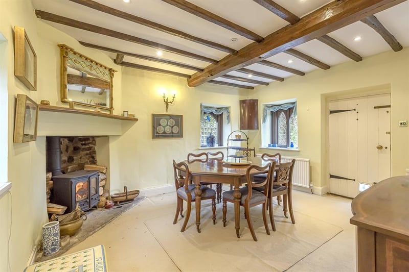 The characterful dining room features a large log burner at its heart, oak ceiling beams and plenty of space for entertaining.