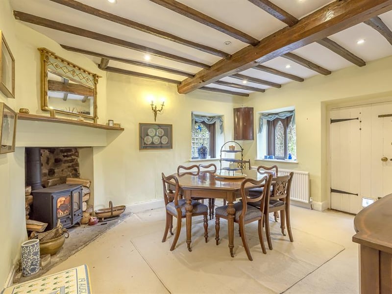 The characterful dining room features a large log burner at its heart, oak ceiling beams and plenty of space for entertaining.