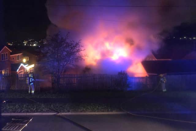 Three vehicles were inside the garage, which fire crews discovered 'well alight' on arrival.