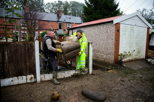 Residents at Tapton Terrace start moving out ruined furniture caught in the floodwaters