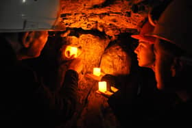 A guided tour showing the Witch Marks in Robin Hood Cave at Creswell Crags.