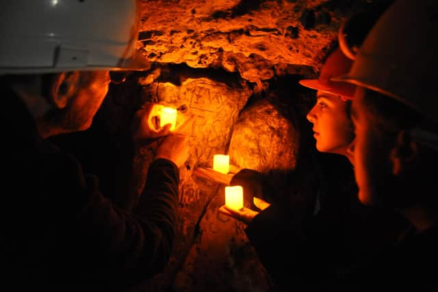 A guided tour showing the Witch Marks in Robin Hood Cave at Creswell Crags.