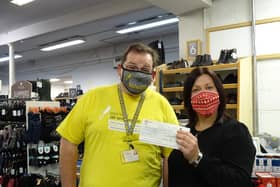 Rachel Brown, store manager at Pavers Shoes in Belper, presents the cheque to Richard Fletcher , voluinteer Derbyshire community representative for DLRAA.