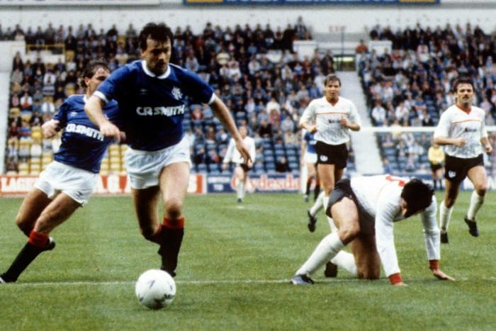Glazing company became the first shirt sponsors in the mid-1980s, adding their glazing company name to the front of the shirts along with manufacturers Umbro - as modelled by Davie Cooper against Clyde in 1985.