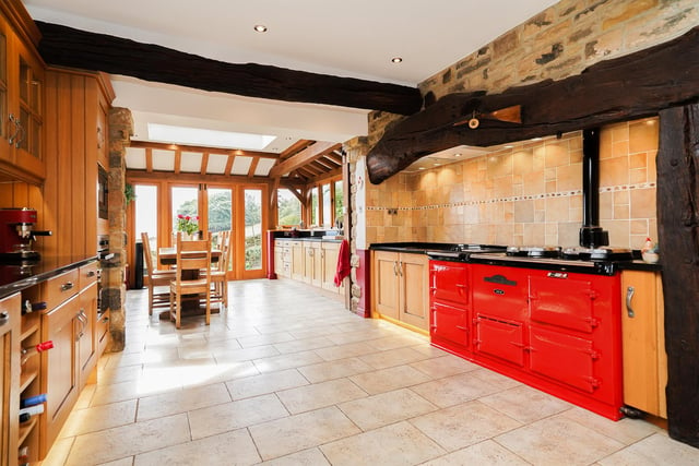 This eye-catching room boasts bespoke cabinetry, granite worktops and an Aga cooker.