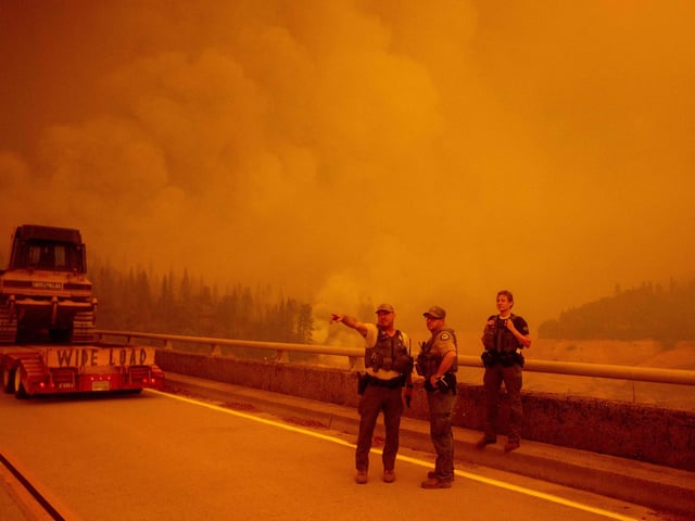 Law enforcement and fire personnel wait on the Enterprise Bridge.