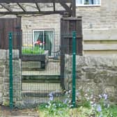 The council has fenced over the garden entrance to the homes and says there are no access rights to its land