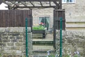 The council has fenced over the garden entrance to the homes and says there are no access rights to its land