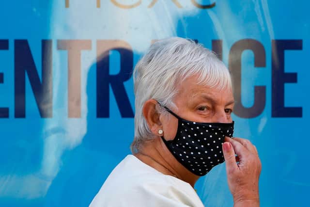 A shopper wearing PPE (personal protective equipment), of a face mask or covering as a precautionary measure against spreading COVID-19.  (Photo by GEOFF CADDICK / AFP) (Photo by GEOFF CADDICK/AFP via Getty Images)