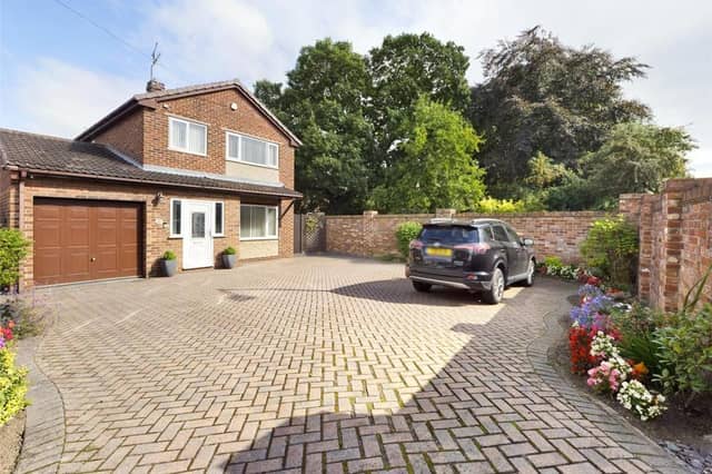 Doncaster Road, Kirk Sandall - Front with boundary wall and fence, block paved, flower beds, a variety of flowers, plants and shrubs, side timber access gate and wrought iron gate providing access to the rear garden.