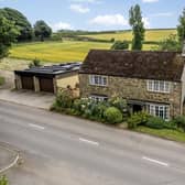 The property is described as a four-bedroom, stone-built detached house.