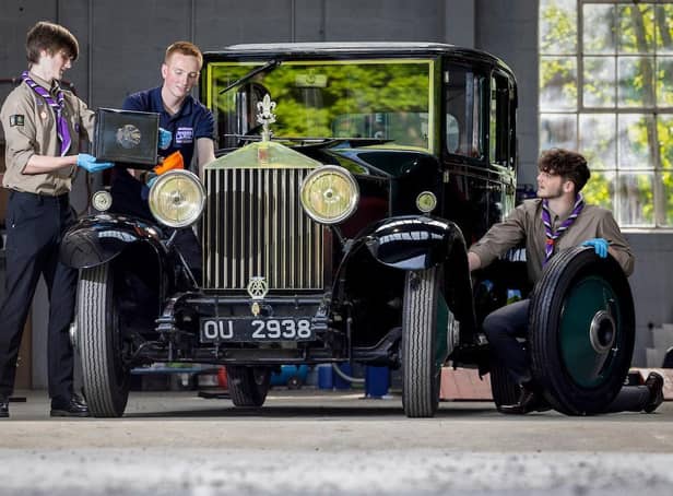 Explorer Scouts Alex Raisin-Moss, 16 (left) and Miles McCarthy, 17 (right) work on their founder’s car at the Great British Car Journey with apprentice heritage vehicle technician, Luke Henshaw  to gain their mechanic activity badge (photo: Rod Kirkpatrick/F Stop Press).