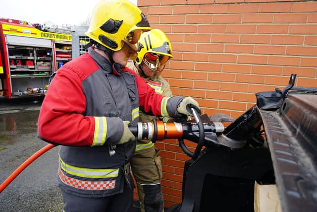 Reporter Tom Hardwick being shown how to use the ‘jaws of life’ by on-call firefighter Richard North.