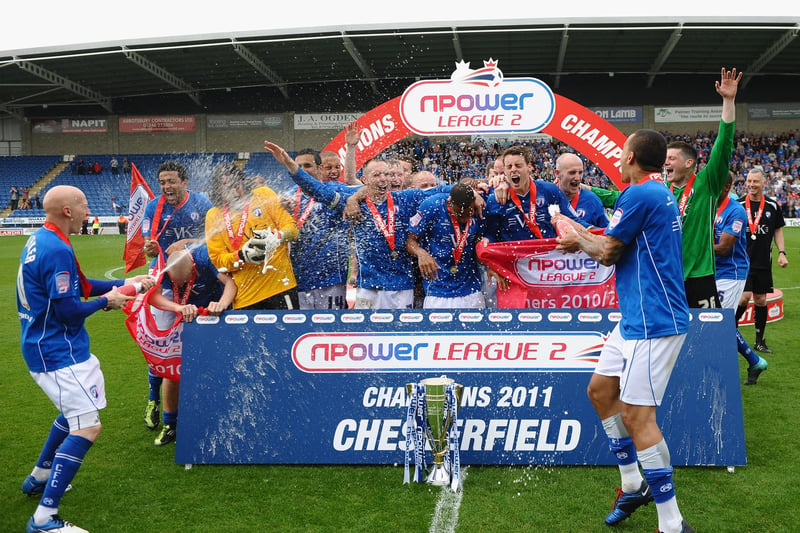 Chesterfield players celebrate with the trophy after being crowned champions.