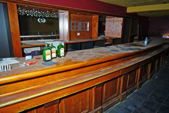 Wood-panelled VIP bar topped by empty Jagermeister bottles.