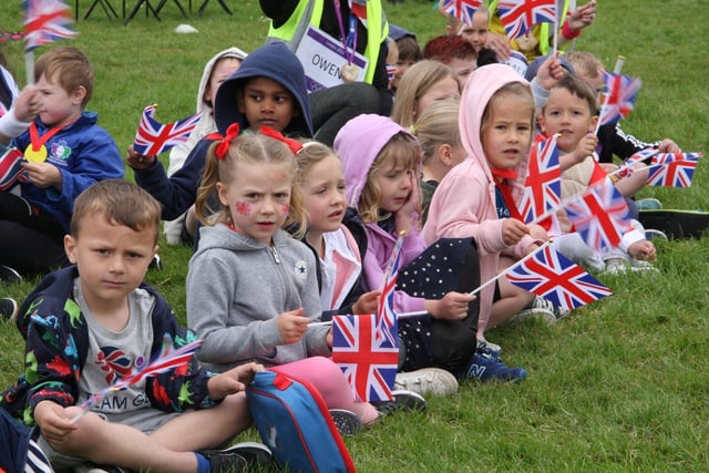Inkersall Spencer Academy pupils waving union jack flags to mark the Platinum Jubilee