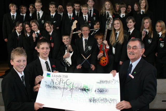 Netherthorpe School helped rasie money for the NSPCC with a charity concert in 2006. Scott Gregory and James Mcmillan hand over the cheque to Malcolm Cowper watched by pupils who took part in the concert.