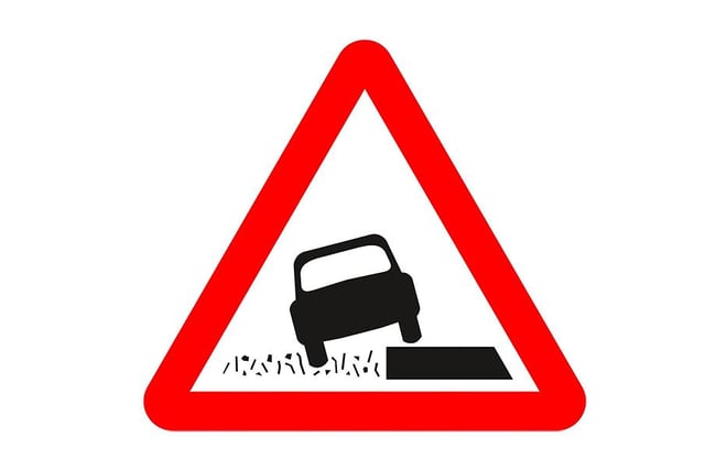 A. Grass banks ahead
B. Quayside or river bank
C. Uneven surfaces
D. Soft verges