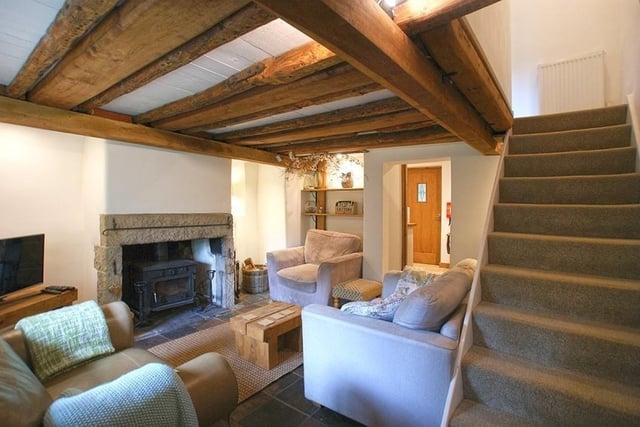 Imagine cosying up in front of the log-burning stove on a cold winter's night in this characterful lounge.  An open staircase rises to the bedrooms and bathroom.
