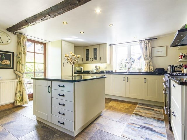 The kitchen contains fitted shaker-style wall, drawer and base units with complementary granite work surfaces and upstands and a central island.  Included in the sale is a range cooker with gas hob, double oven and extractor hood. Integrated appliances include a fridge and dishwasher. There is electric underfloor heating.