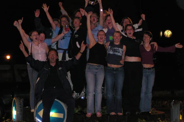 The team celebrating in Matlock's Crown Square when they arrived home at around 2am.