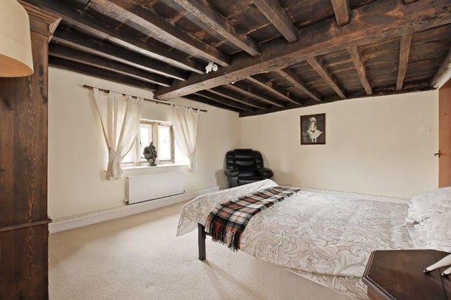 This double bedroom is generous in size and has a fabulous oak panelled ceiling a feature fireplace and a rear facing window.