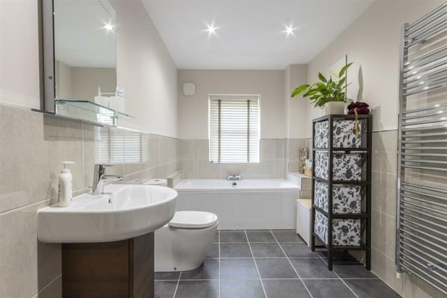 The family bathroom has a four-piece suite in white with a corner shower cubicle, bath, wash basin and wc.