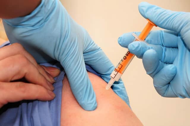 People are being reminded they can get a flu vaccination at a pharmacy. LEWIS WHYLD/AFP via Getty Images