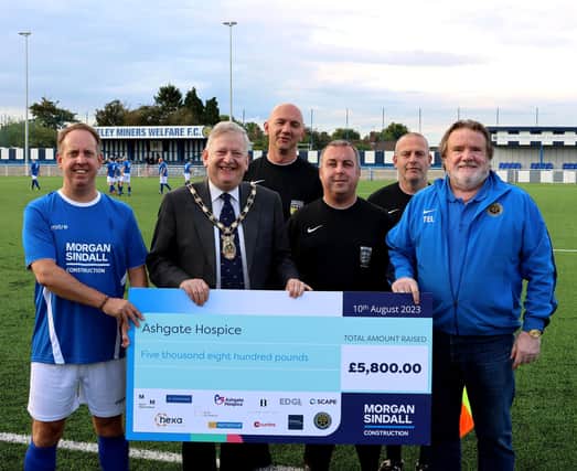 Councillor Martin Thacker being presented with a cheque for Ashgate Hospice at a charity football game held at Staveley Miners welfare, this August.
