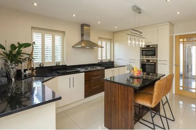 The open-plan kitchen has polished granite worktops and  integrated applicances. A breakfast bar is perfectly placed for informal meals.