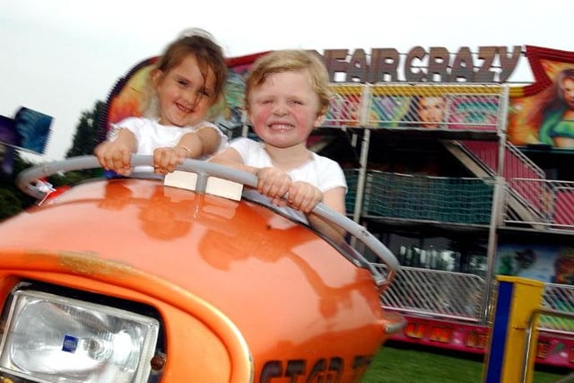 On August 17, 2004 there was a fair in Balby. These two young children are enjoying a ride.