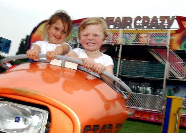 On August 17, 2004 there was a fair in Balby. These two young children are enjoying a ride.