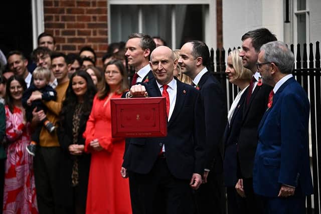 Britain's Chancellor of the Exchequer, John Healey, holds up the traditional red ministerial box outside No 11 Downing Street before departing to the House of Commons to deliver the first budget under Prime Minister Andy Burnham's government on October 28, 2026 in London, England. (Photo by Dylan Martinez - WPA Pool/Getty Images)